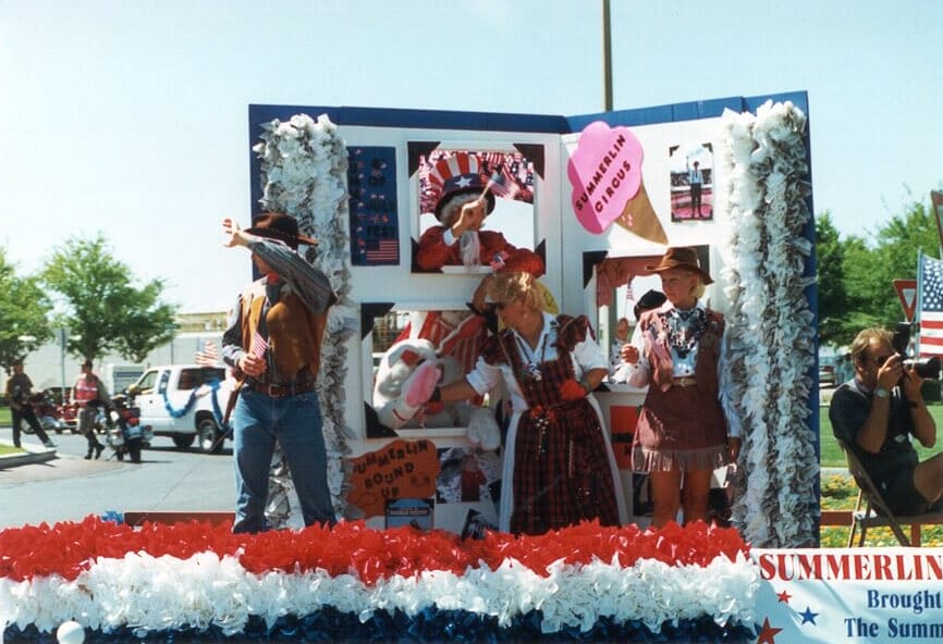 Throughout the years, floats in the Patriotic Parade grew more creative and ambitious as seen in this living photo album example.